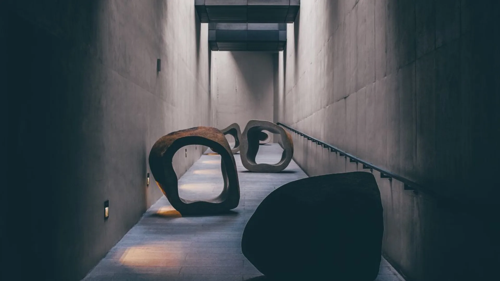 Sculptural lounge chair standing alone in a bare plaster gallery room