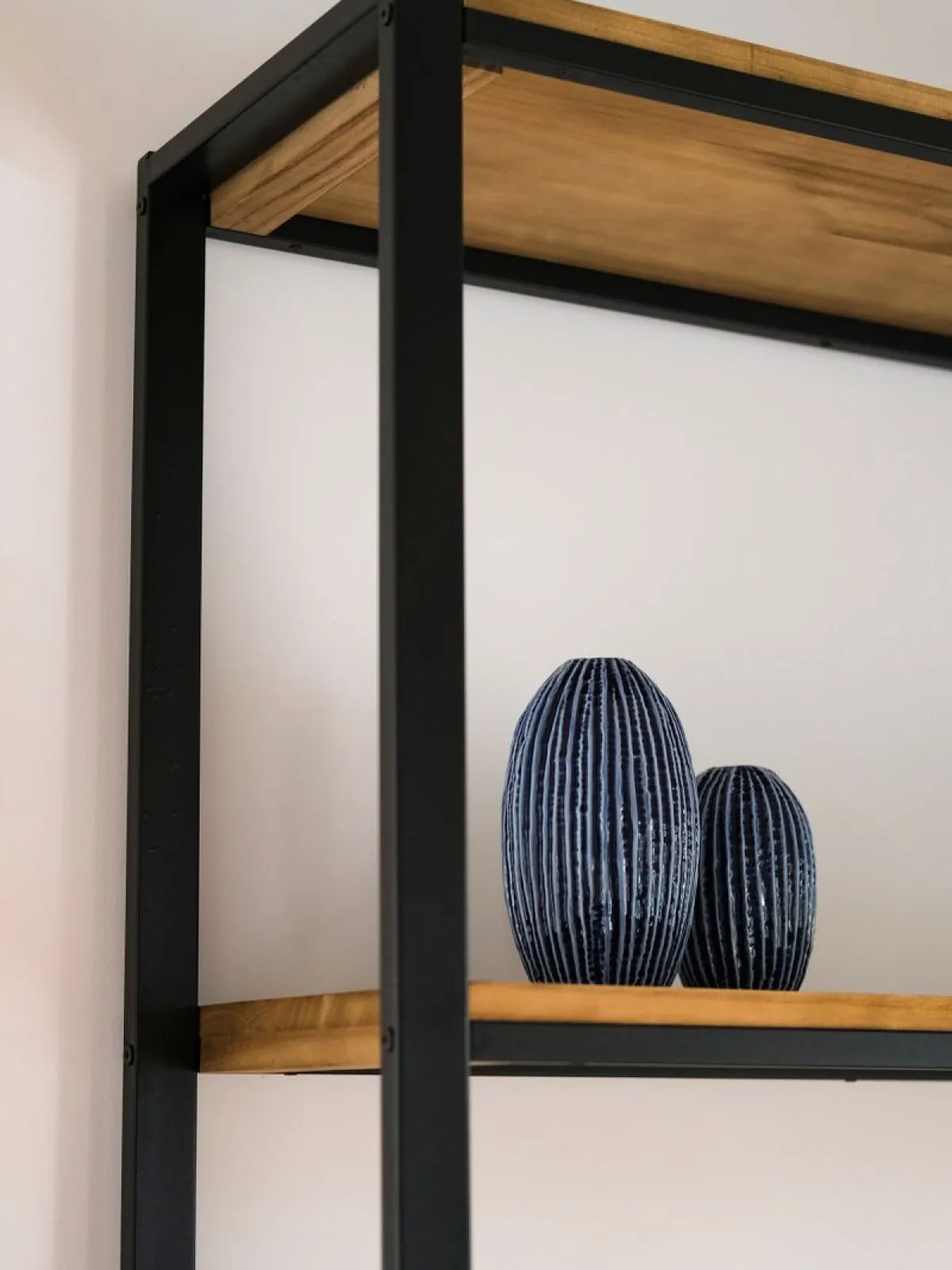 Quiet gallery-like interior with tall windows and a few furniture pieces